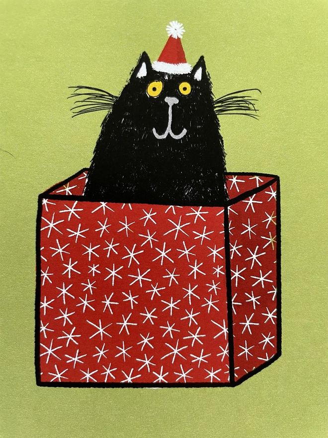 Illustration of black cat sitting in a christmas box