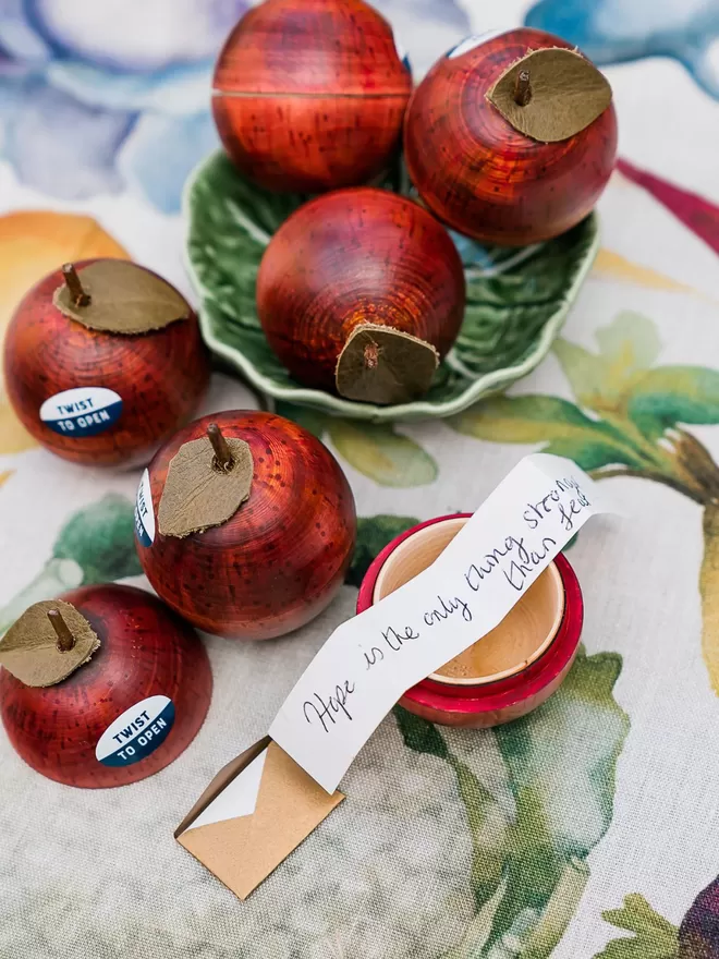 Wooden apple ornaments with a secret compartment and message