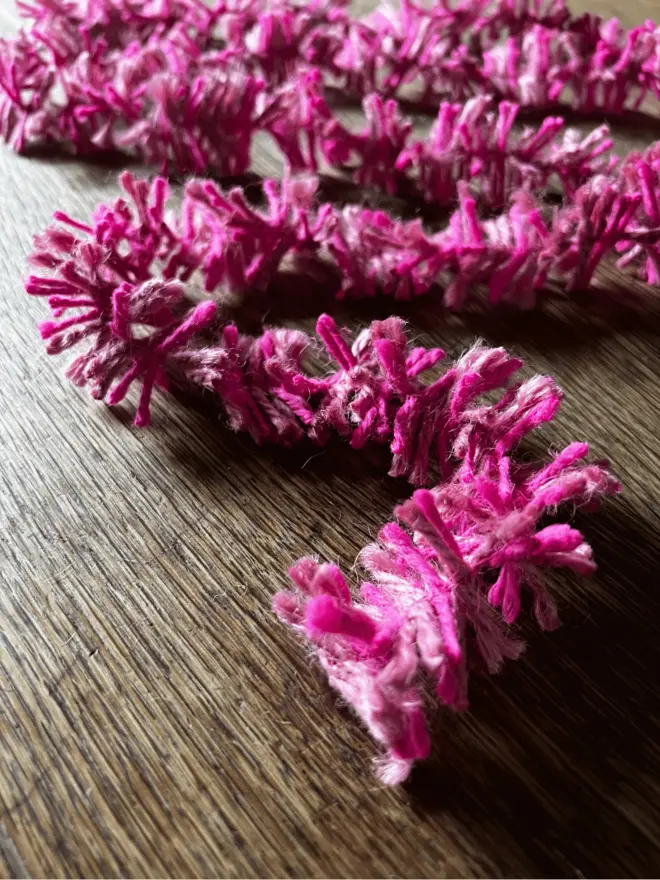 Pink Pop Strinsel AKA Jute string tinsel on an oak table