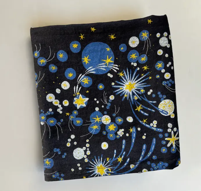 Solaris Tablecloth In White Or Blue. Blue tablecloth with blue and yellow starburst motifs.