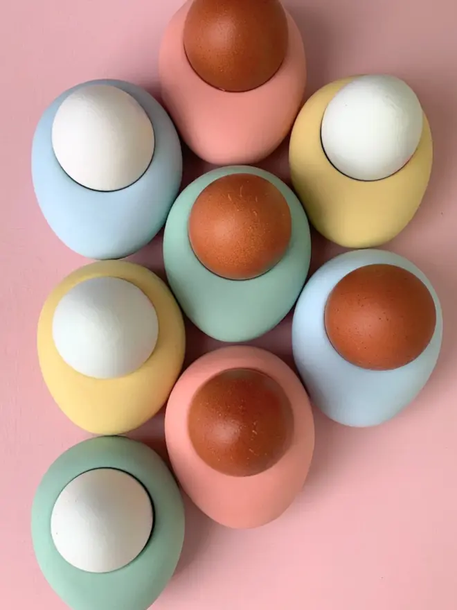 colourful egg cups with brown and white eggs
