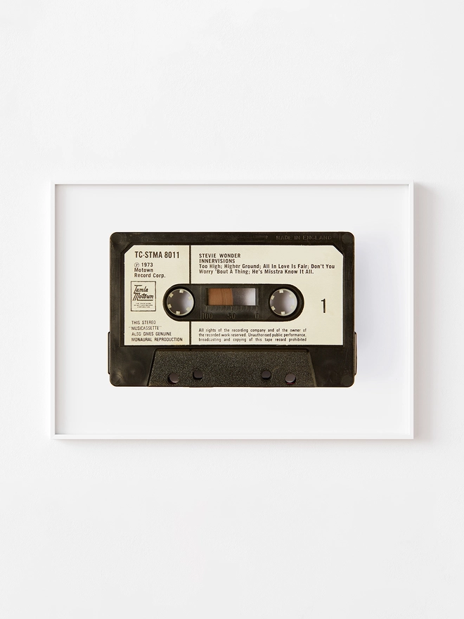 stevie wonder innervisions cassette tape print. framed print hung up on white wall.