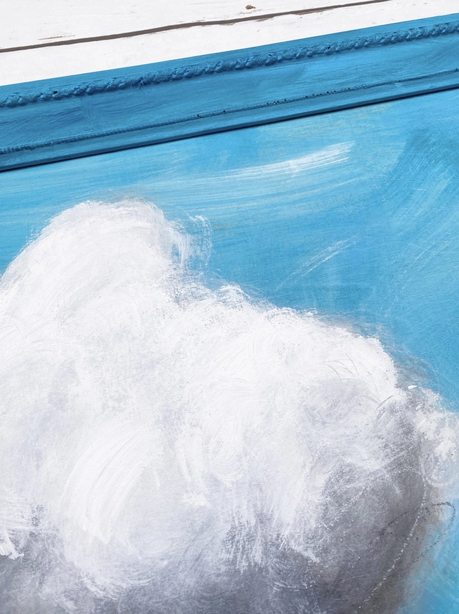large cloud painting in turquoise painted directly onto a frame