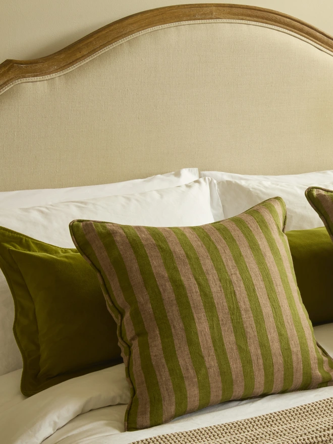 Handmade scalloped velvet bolster cushion 130cm with feather pad paired with stripe linen cushions on bed, Kika Bespoke