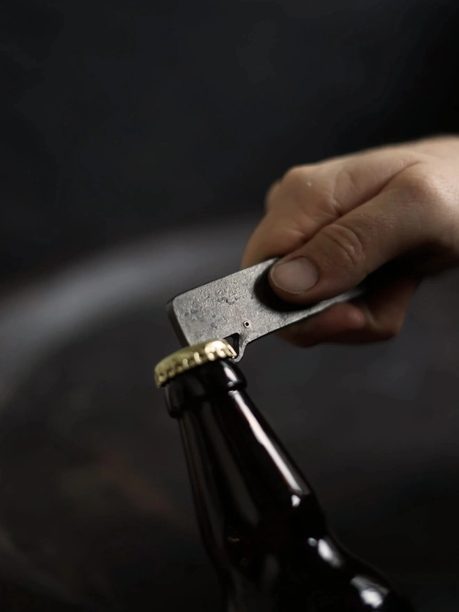 Whale Bottle Opener, a person opening a bottle with a whale bottle opener. 