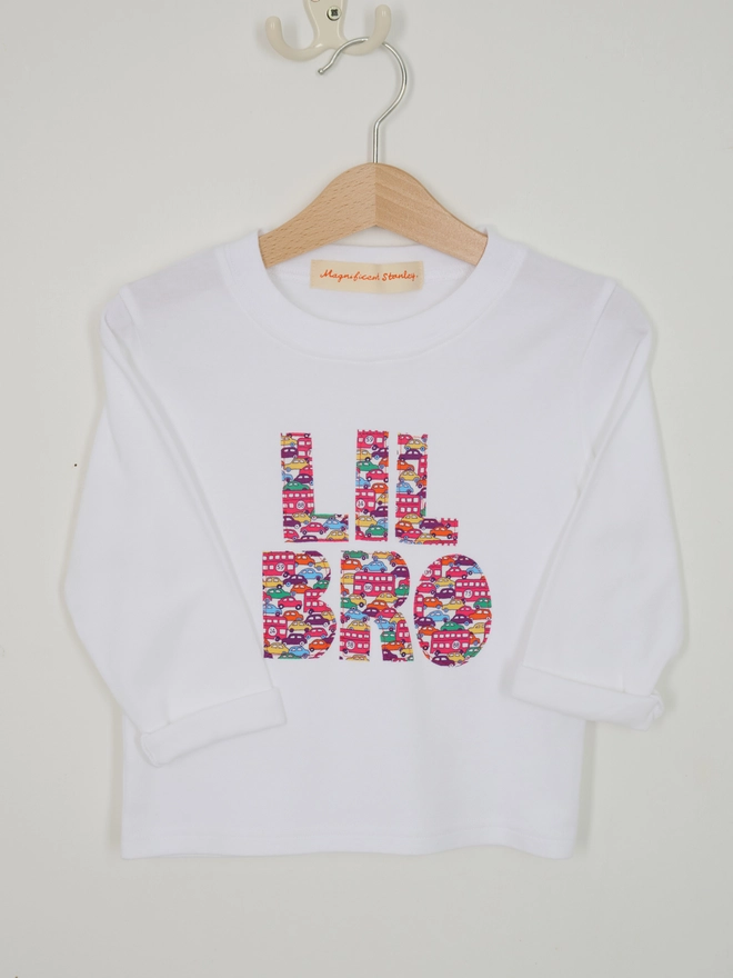 a white kids t-shirt with Lil Bro sewn on in letters cut from Liberty cars print 