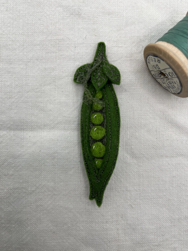 close up of Pea pod brooch