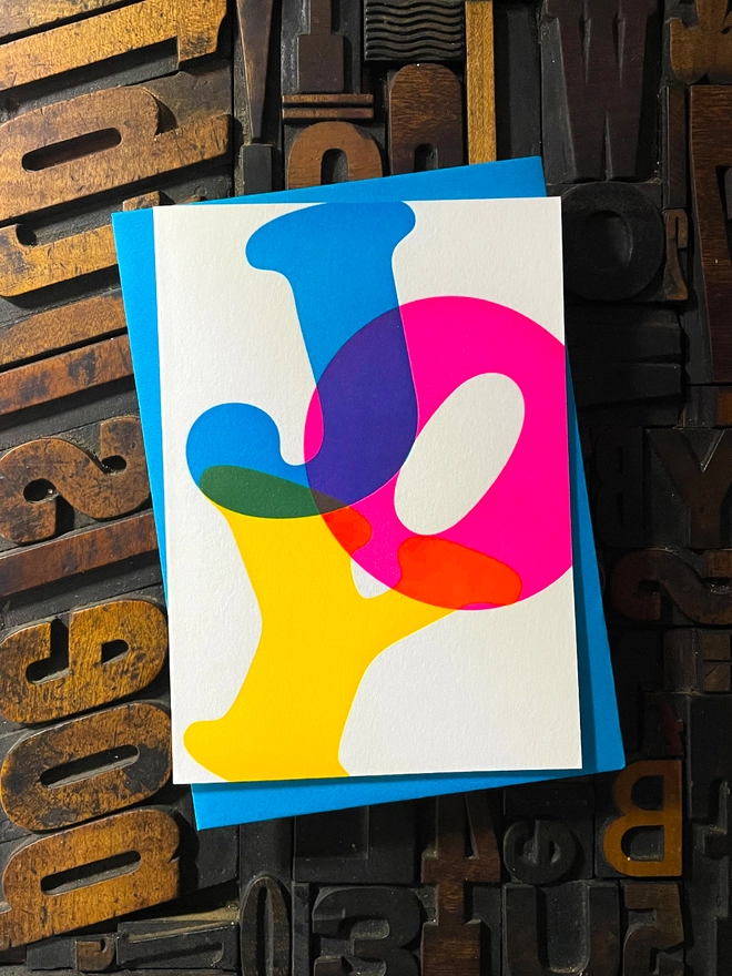 Noel, Joy, Hope; A beautiful typographic set of letterpress Christmas cards. Printed with rich vibrant and fluorescent blue, magenta and yellow inks with luxury matching and contrasting envelopes; ideal to send to your designer friends at the festive season.