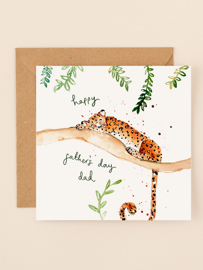 An illustration of a relaxed leopard lounging on a tree branch, exuding a laid-back vibe. The leopard's eyes are half-closed, and its body is stretched out comfortably. Above the scene, the handwritten message "Happy Father's Day Dad" adds a personal touch. The card's design combines playful animal imagery with a heartfelt sentiment, perfect for Father's Day.