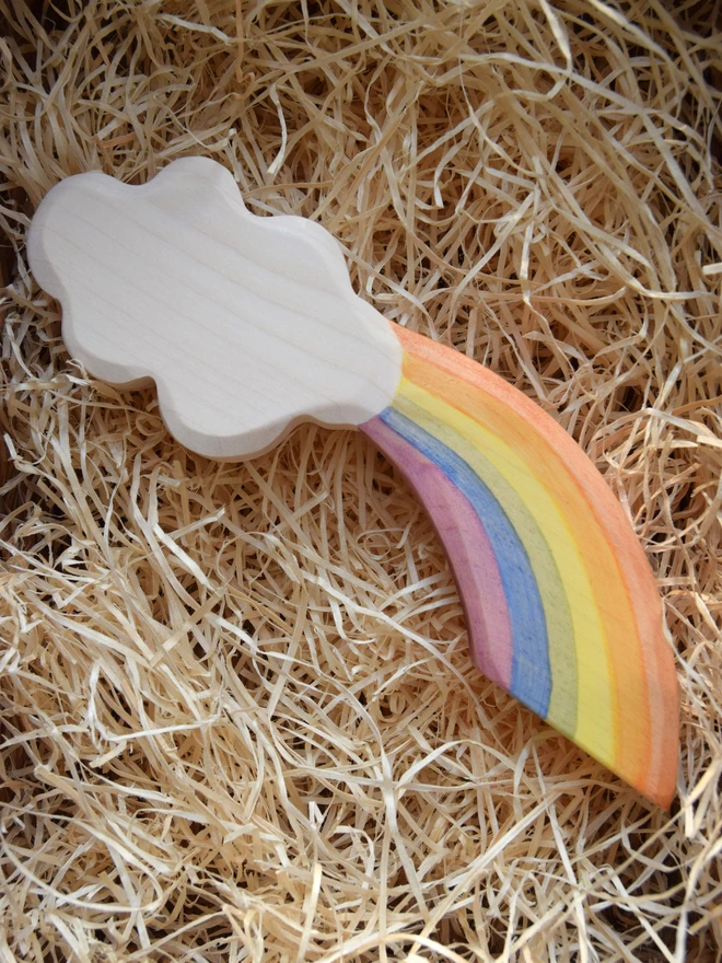 wooden toy rainbow cloud in woodwool