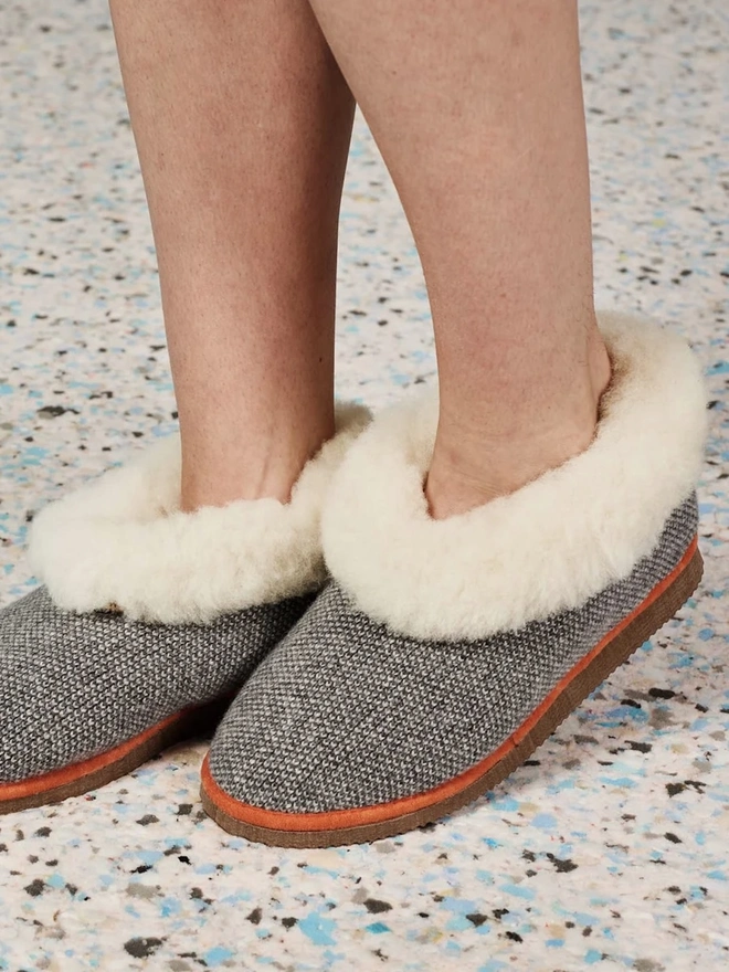 Lambswool & Sheepskin Slippers, a person wearing a pair of colourful lambswool and sheepskin slippers. 