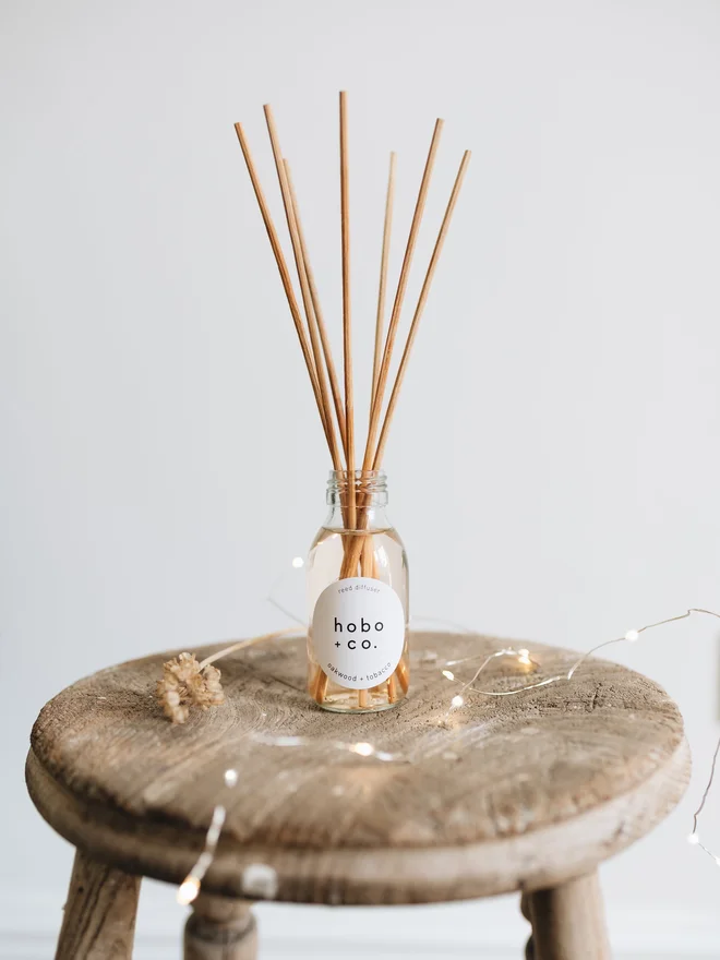 oakwood and tobacco reed diffuser with fairy lights