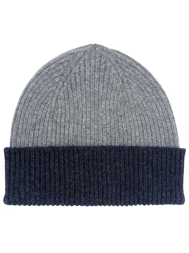 Ribbed Lambswool Women's Beanie, a colourful beanie sitting on a white plain surface. 