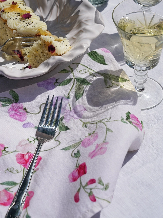 Linen napkin next to wine and cake