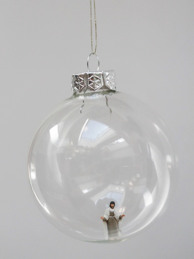 Miniature figure of Jesus in a glass hanging christmas bauble 