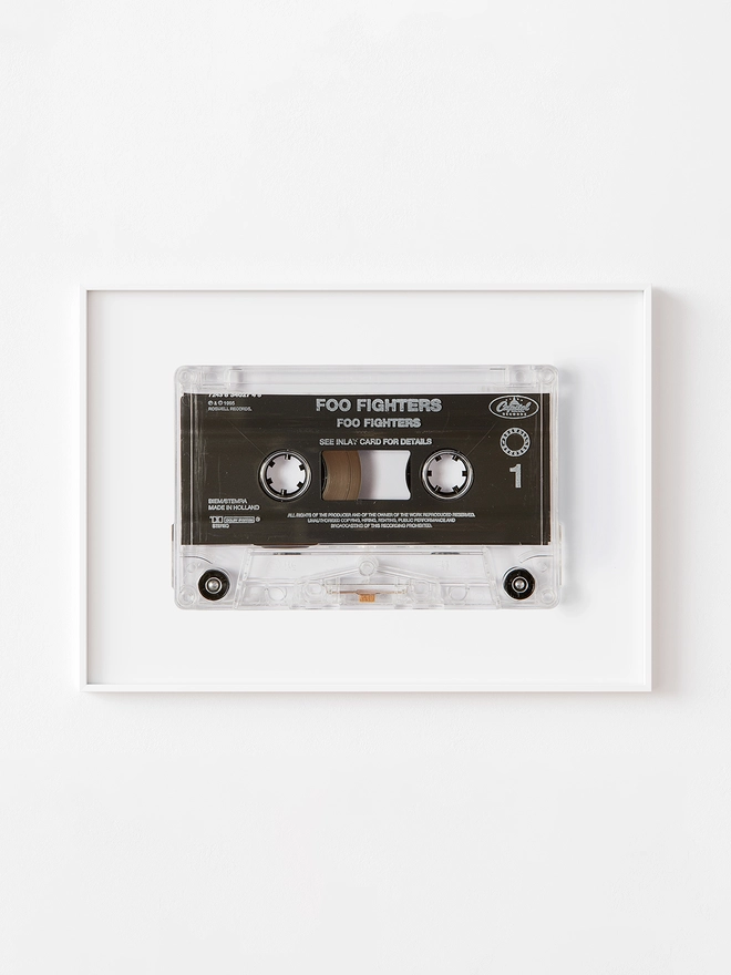 foo fighters cassette tape print. framed print hung on white wall.