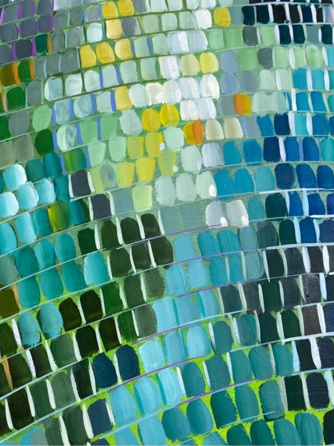 a close up view of a green and blue painting