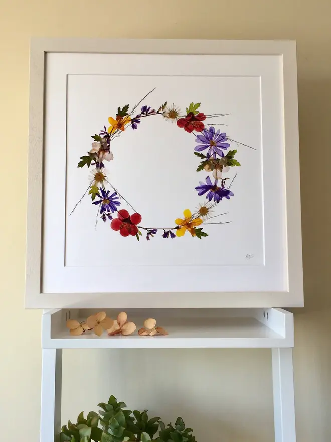 Pressed Wildflower Letter Print, a wildflower alphabet letter print sitting framed. 