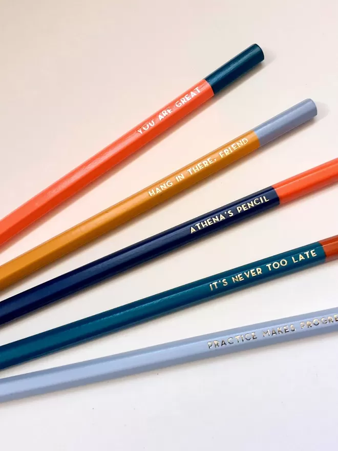 Meticulous Ink Personalised Pencils seen in different colourways with gold phrases.