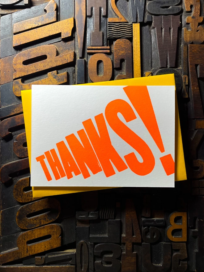 Thanks! A vibrant thank you typographic letterpress card with deep impression print using fluorescent orange, with a range of colourful envelopes. Slight print variations adding to the style anding to the charm of this handmade greeting card.