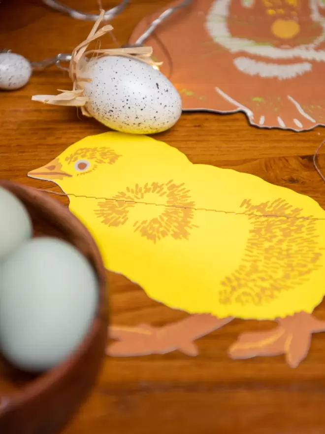 Yellow chick on brown wooden table