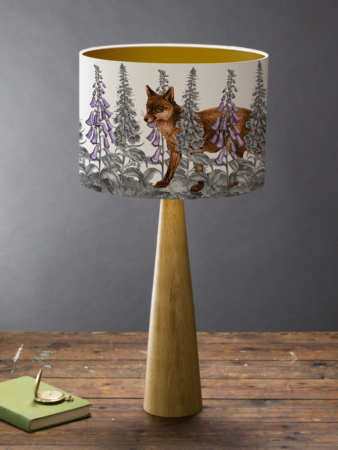 Handmade lampshade featuring a mischievous fox moving through foxglove flowers in a whimsical woodland design.