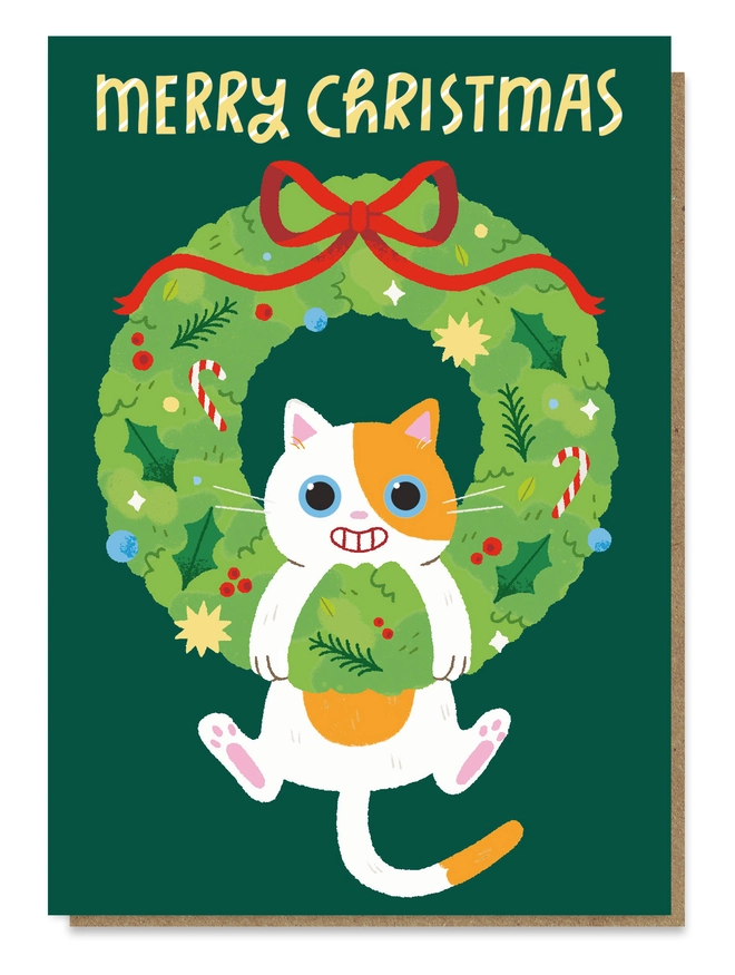 Greeting card with an illustration of a ginger and white cat hanging from a Christmas wreath
