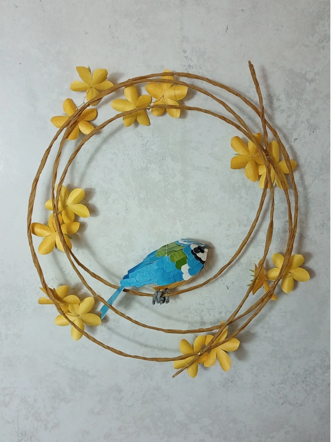 Back view of a blue tit sculpture wall hanging.