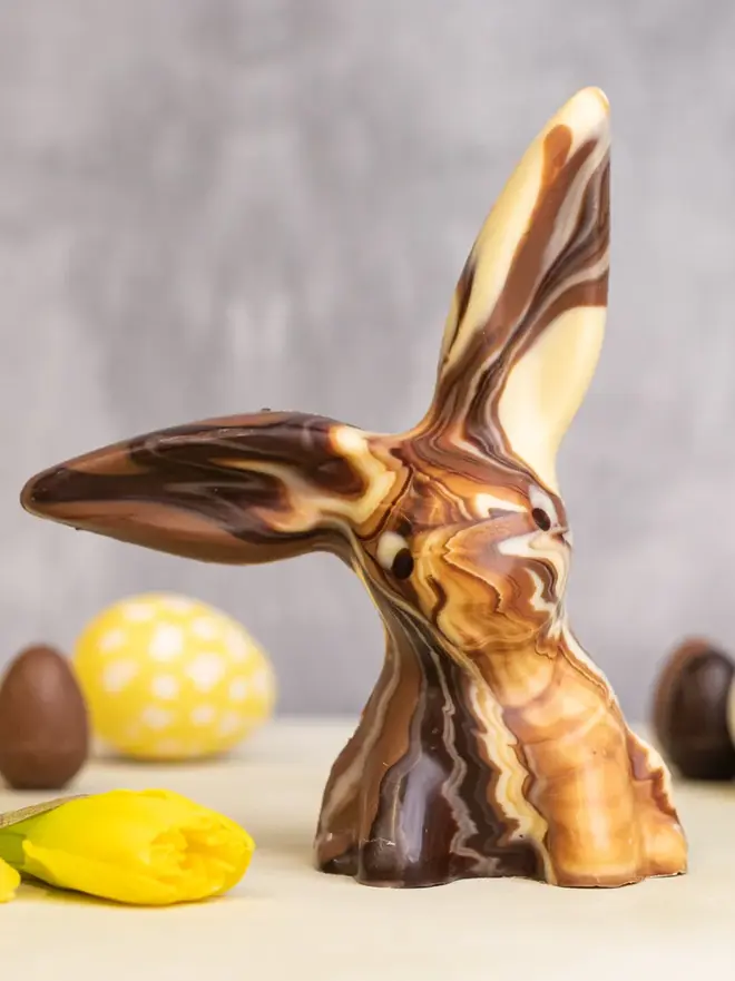 Solid Marbled Chocolate Bunny on a table with easter eggs