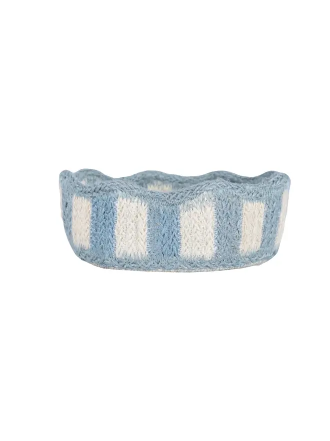 Blue scalloped mini jute basket on a white background. 