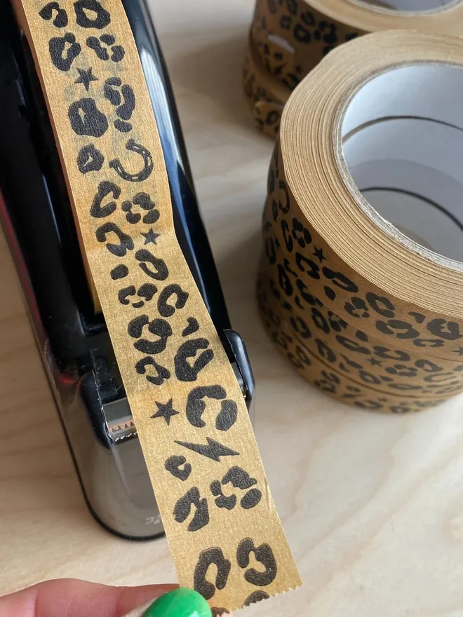 Leopard print  adhesive paper tape on a dispenser. 