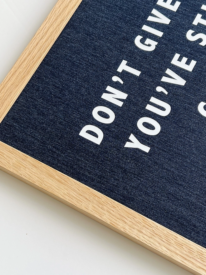 Denim with white quote framed print - corner close up