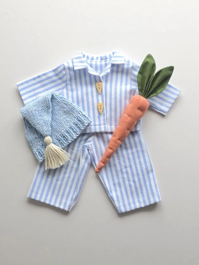 Handmade Gerald Bunny blue striped pyjama outfit with matching knitted sleepy hat and linen carrot, designed by Verity Isabelle for Christmas.