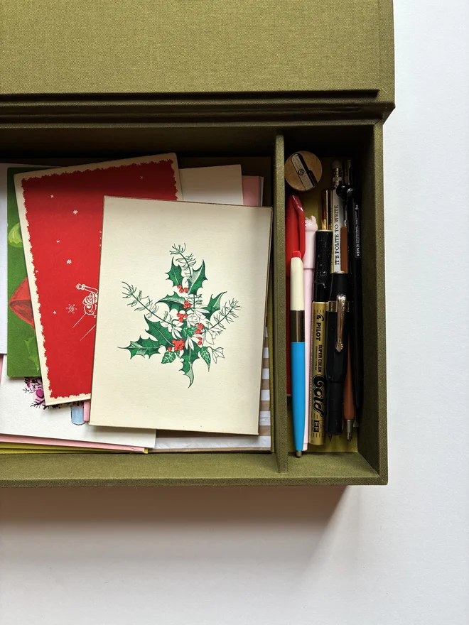 Open handmade Christmas Correspondence box in Olive green cloth displaying cards and stationery items