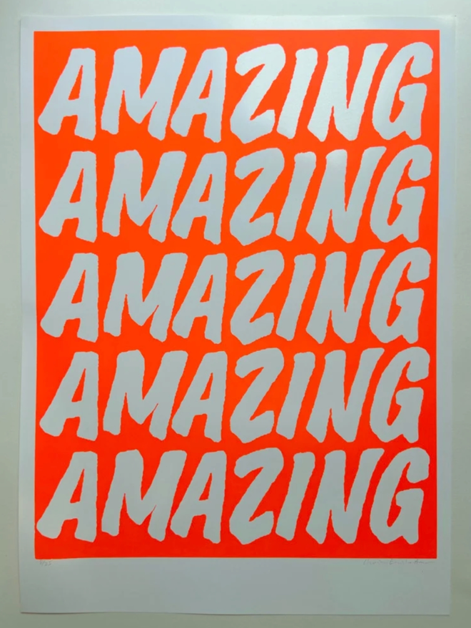 Fluoro Amazing Print. A vibrant orange background with AMAZING written five times.