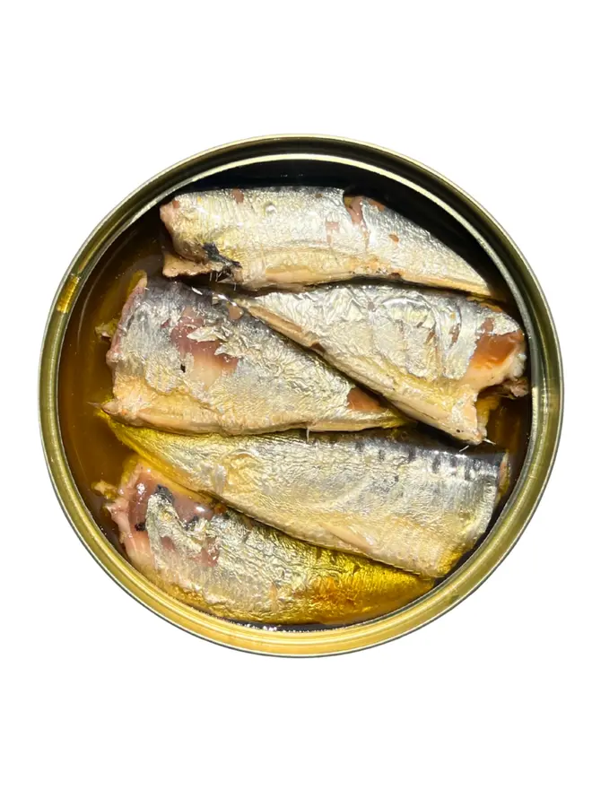 An open tin of Sea Sisters Cornish Sardines with Chill Extra Virgin Olive Oil on a white background