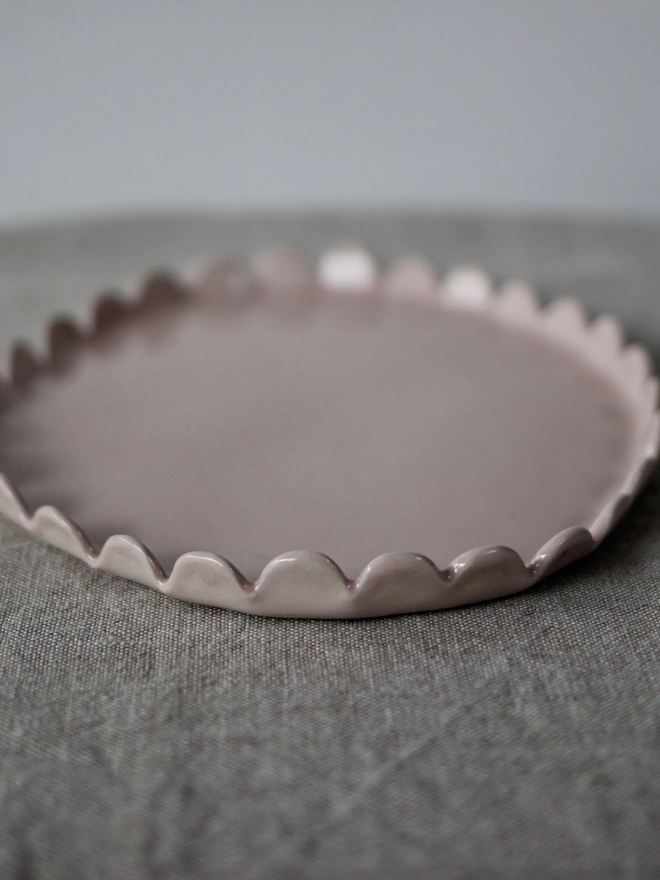 side view of oval pale pink plate for serving food