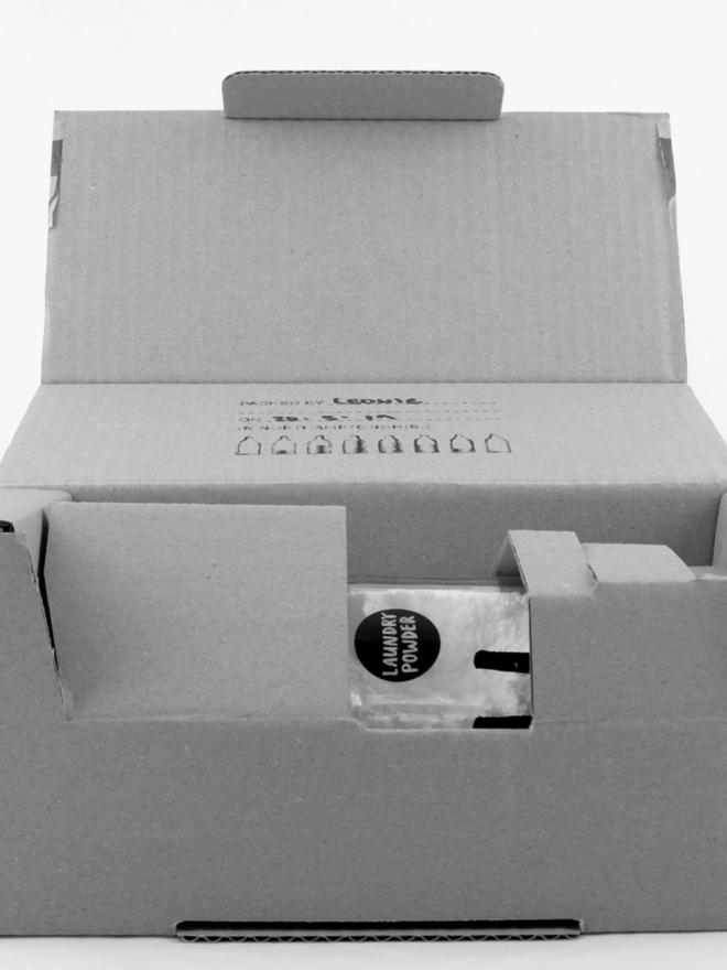 Laundry Powder. A jar of white laundry powder in a cardboard box.