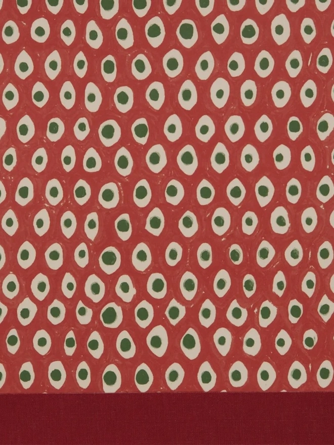 Retro Drum Lampshade. Close-up of a hand block printed lampshade showing a bold repeating geometric pattern. The colourful printed design and neat trim bring character and a handcrafted finish to any lamp.