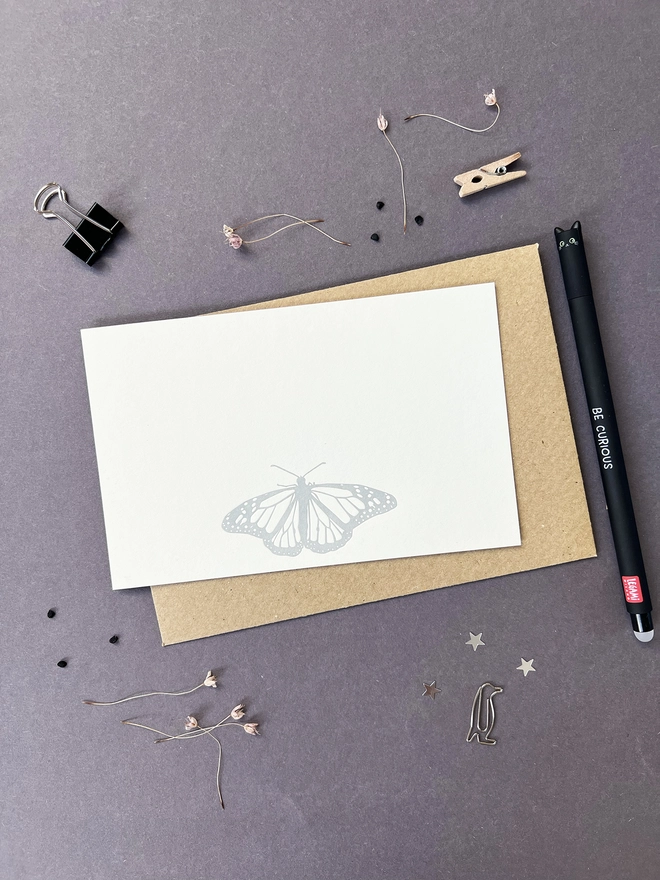 flat letterpress correspondence card printed with a silver butterfly