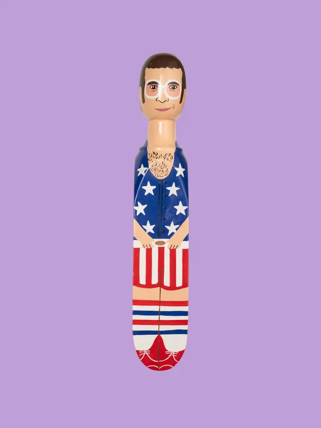 Wooden Door Stopper (Elty Stars & Stripes Outfit), a colourful wooden door stop sitting on a white surface. 