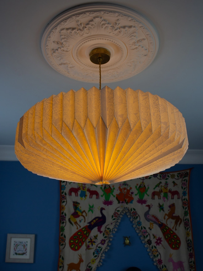 White origami lightshade hanging from ceiling 