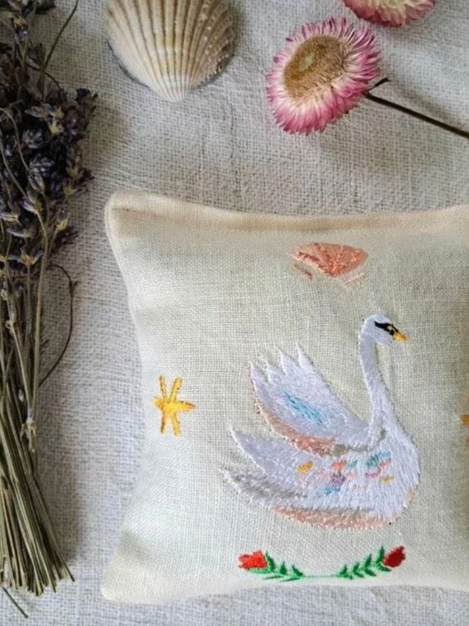 Swan Lavender Sachet. A sachet patterned with seashells and a swan.