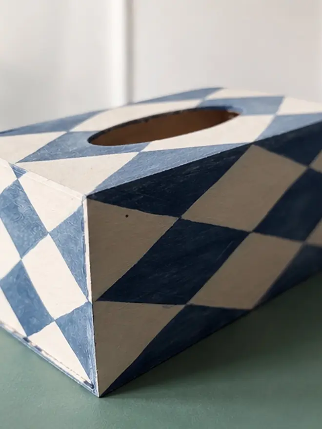 hand-painted harlequin tissue box. a tissue box in blue and white painted harlequin pattern.