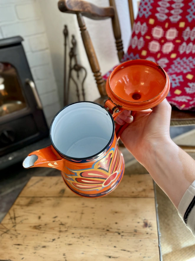 Inside of orange coffee pot shows the enamel is in pristine condition