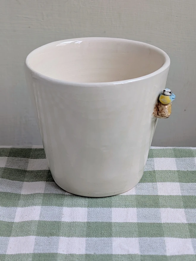 blue tit espresso coffee cups with a tiny handmade bird resting on a small ceramic tree branch in white earthenware pottery