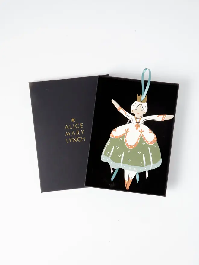 Belle Tree Dancer. wooden hanging ballerina decoration in an open black gift box embossed "alice mary lynch" in gold, with sage green floral skirt, cream bodice and duck egg blue ribbon ties