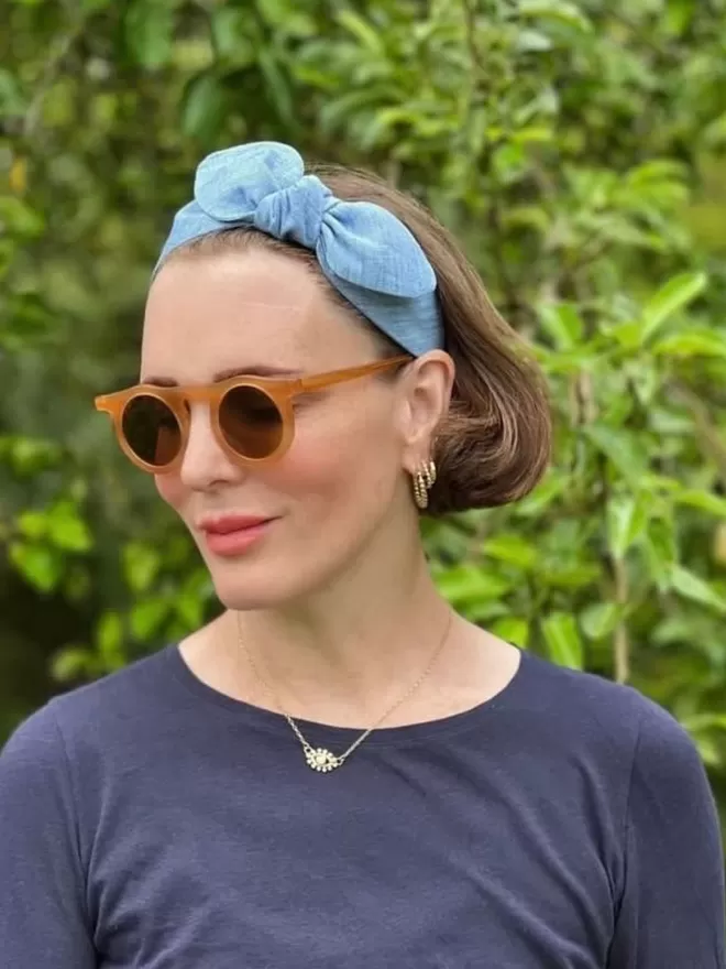 Vanessa Rose Celeste Hairband in Flax Blue seen on a woman.