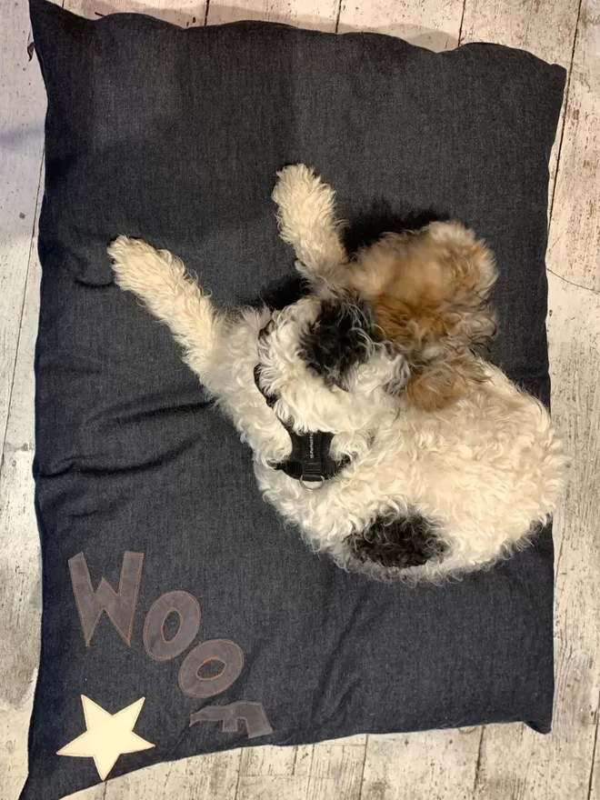 Woof Dog Bed in grey on denim with orange stitching 