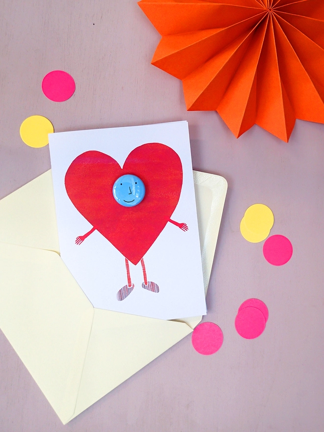 greeting card with happy heart and pin badge